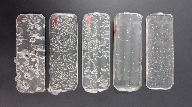 Compression molded plates of PLA. Attempts go from left to right, with the first on the left.