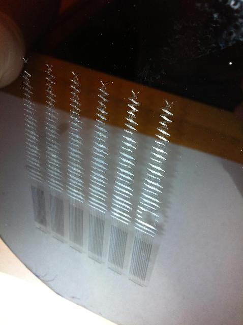 This is the master from which we will create our PDMS microfluidic devices. From this picture it is easy to see how small this device truly is, reference the thumb in the upper left.