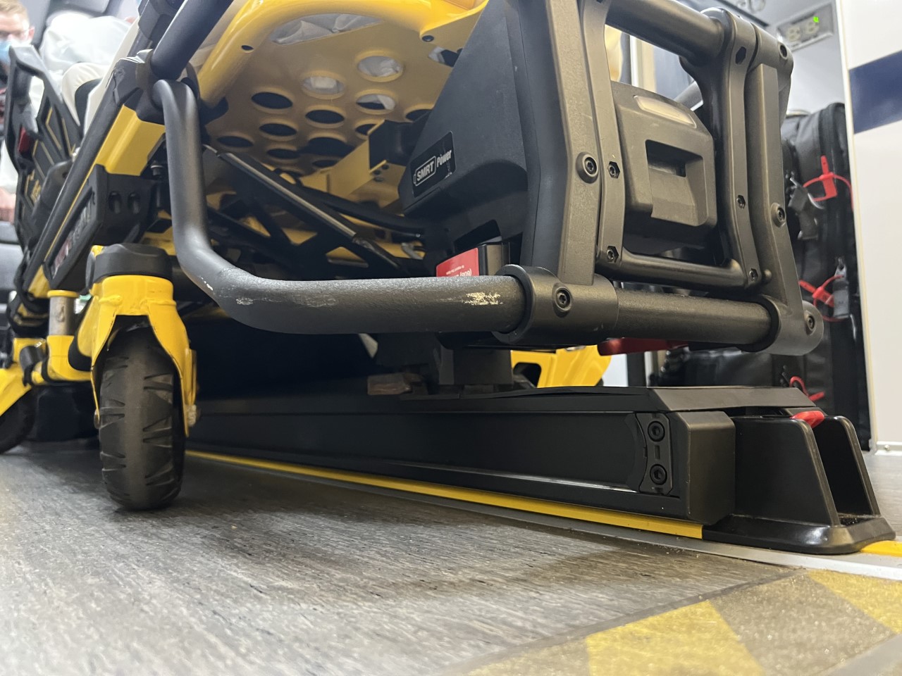 Ambulance gurney locking mechanism