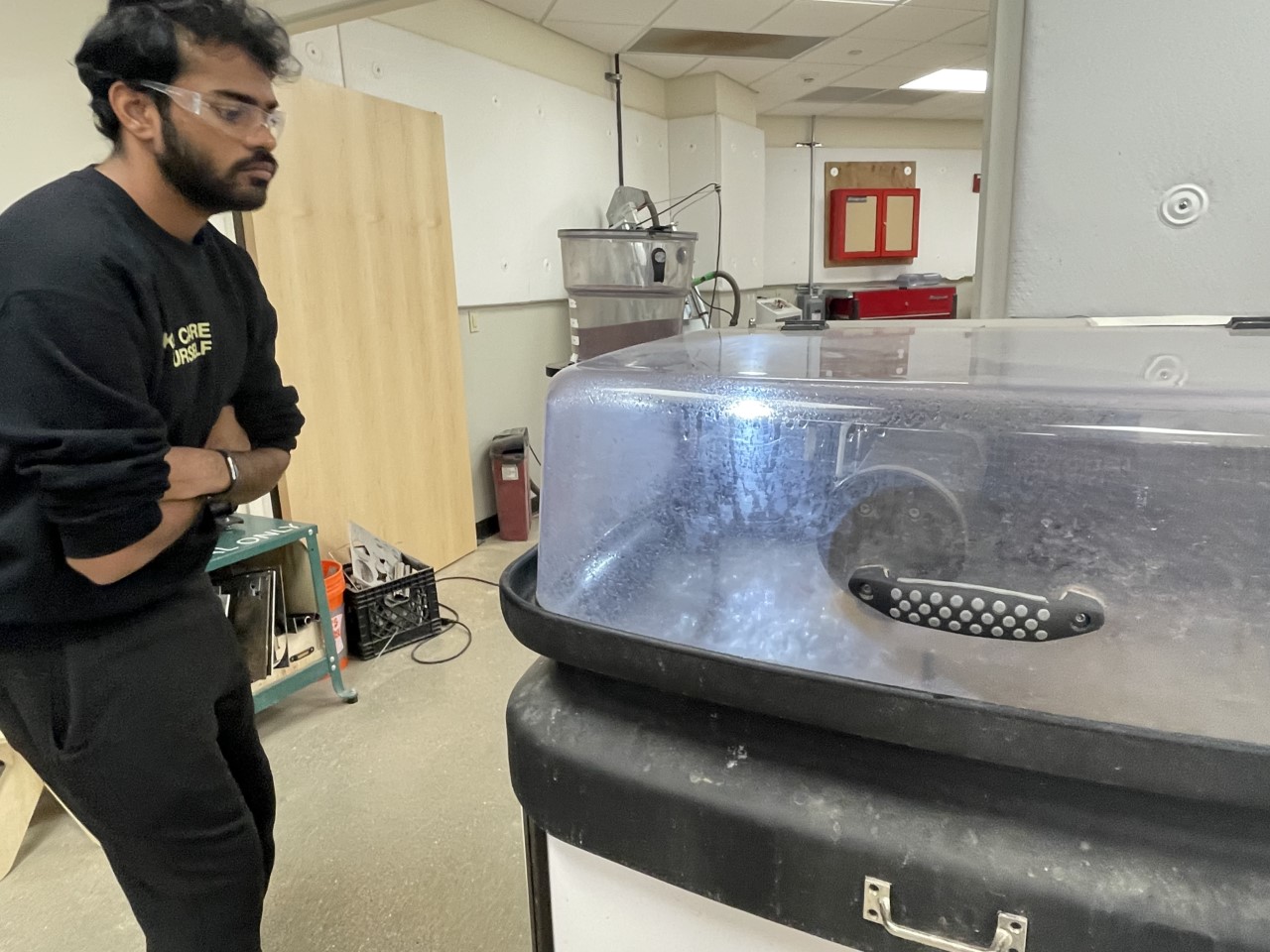 Josh watching the water jet cut the corner damper case.