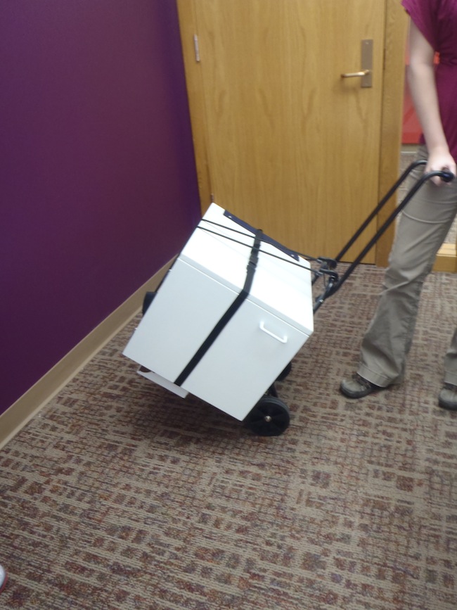 Chair and storage box attached to the transportation cart.