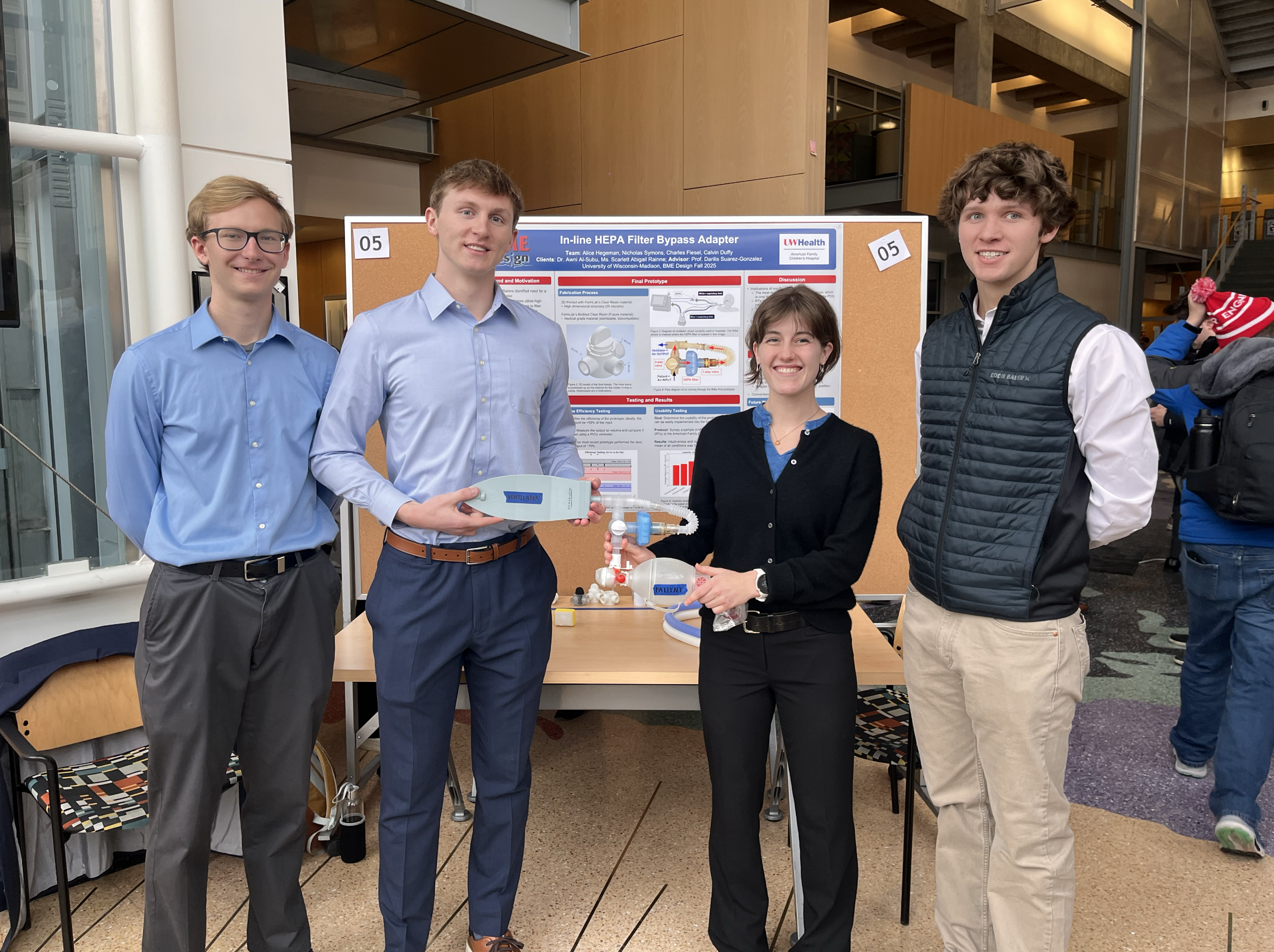 Fall 2026 final poster presentation. From left to right: Nicholas Symons, Calvin Duffy, Alice Hegeman, Charles Fiesel